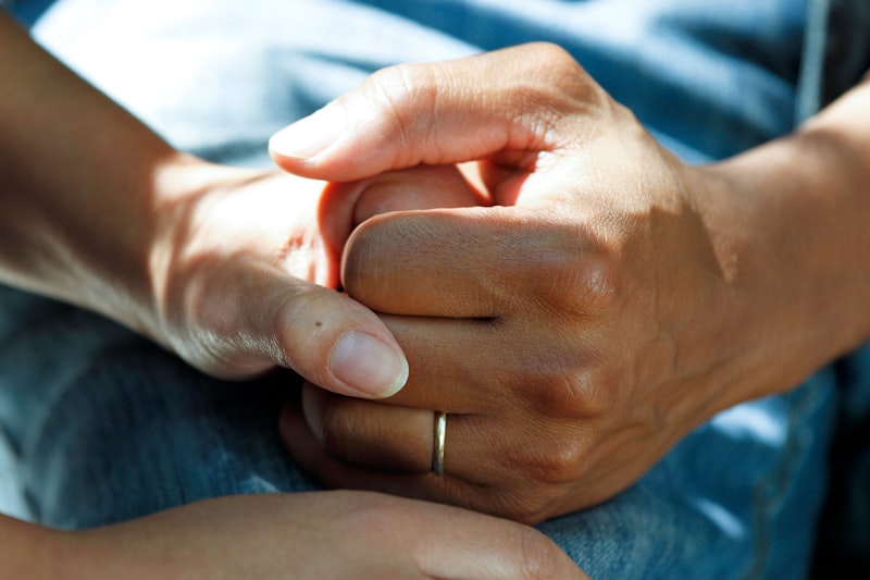 Two people holding hands showing support and connection